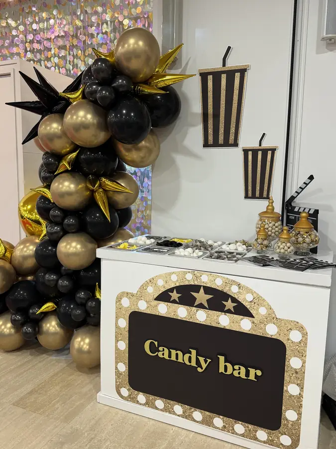 Cinema marquee sign reading ‘Candy bar’ in black and gold