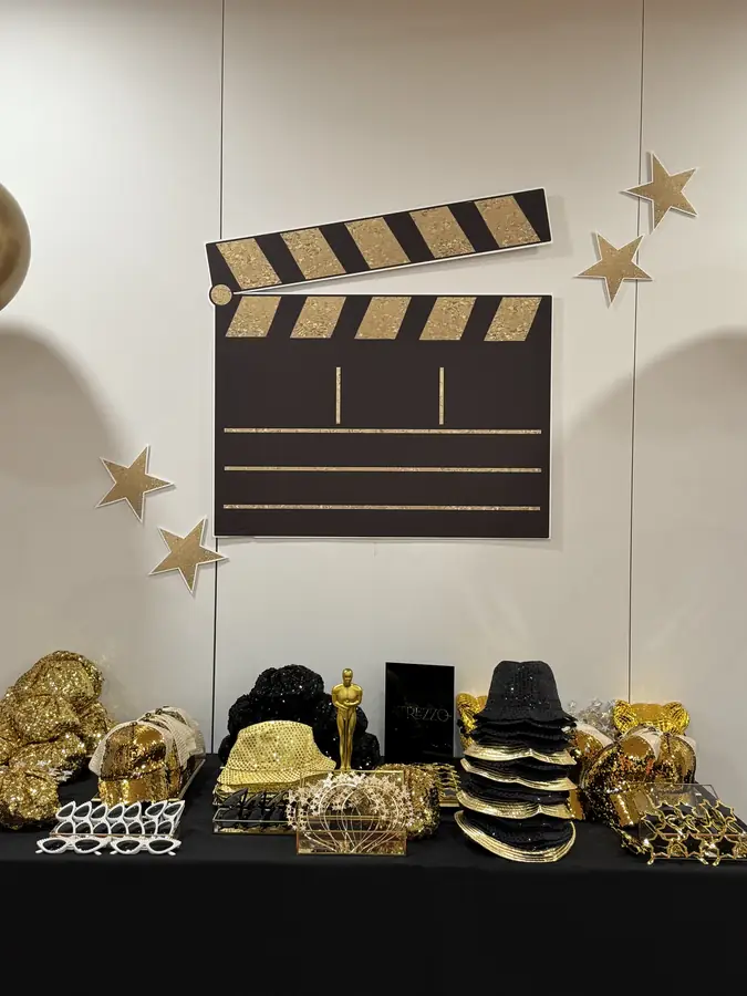 Styling details with clapperboard and black and gold props