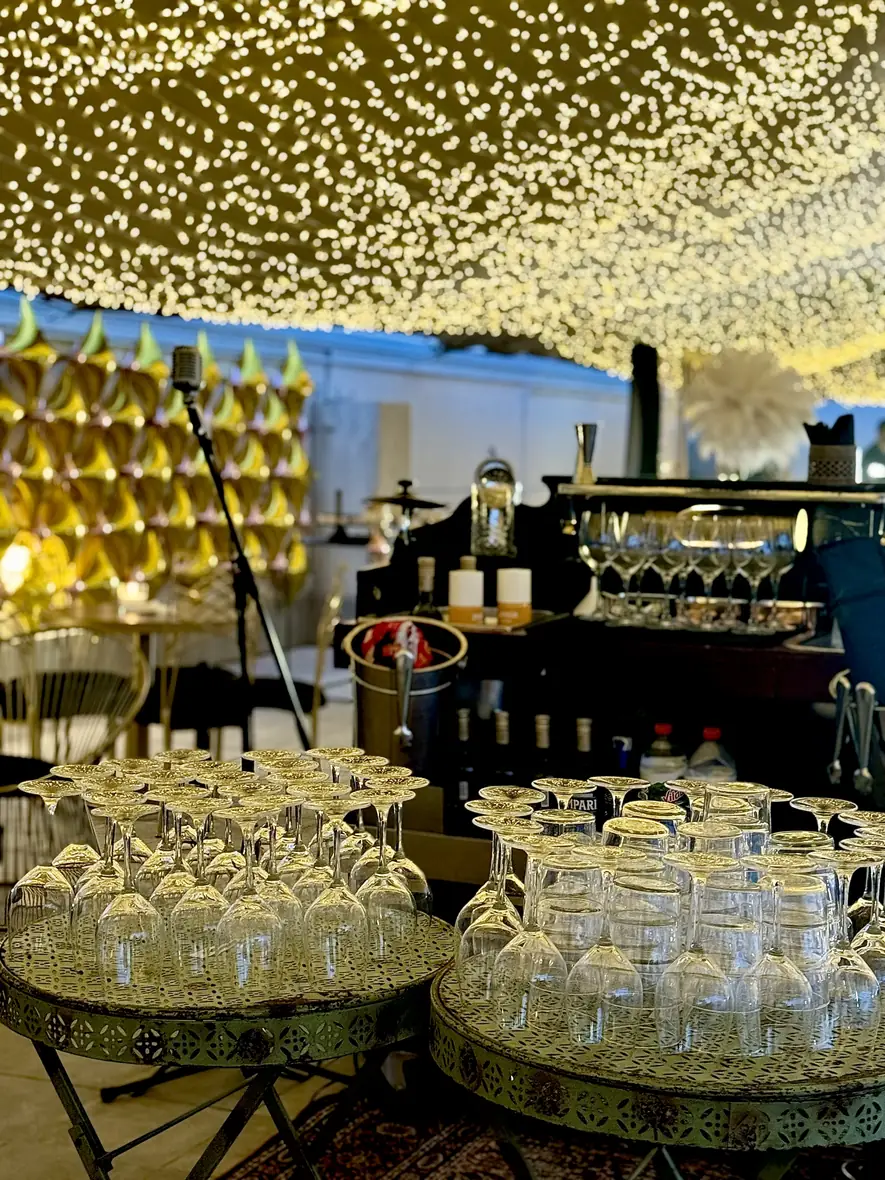 Illuminated gold scallop wall with warm-lit dessert stations