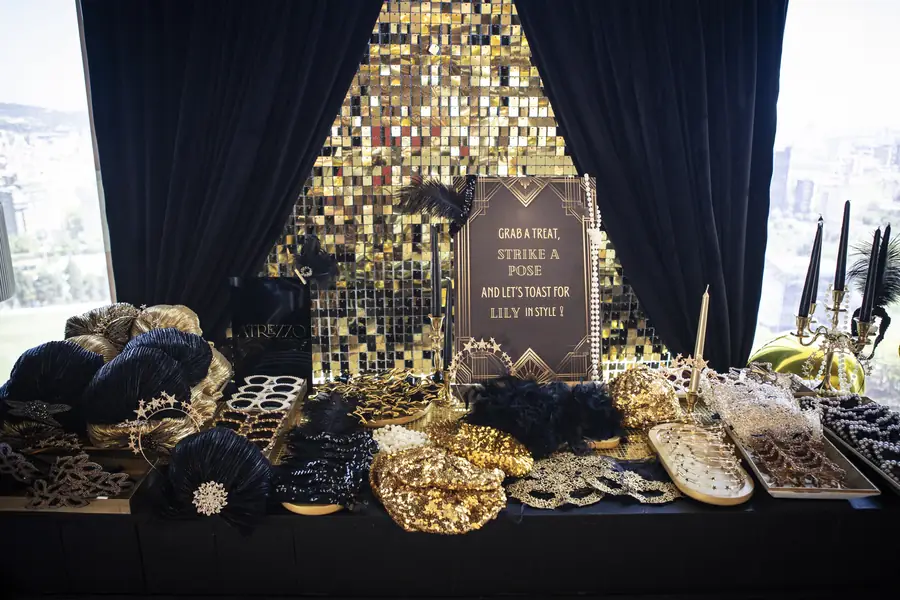 Gold sequin wall with masquerade masks and navy velvet