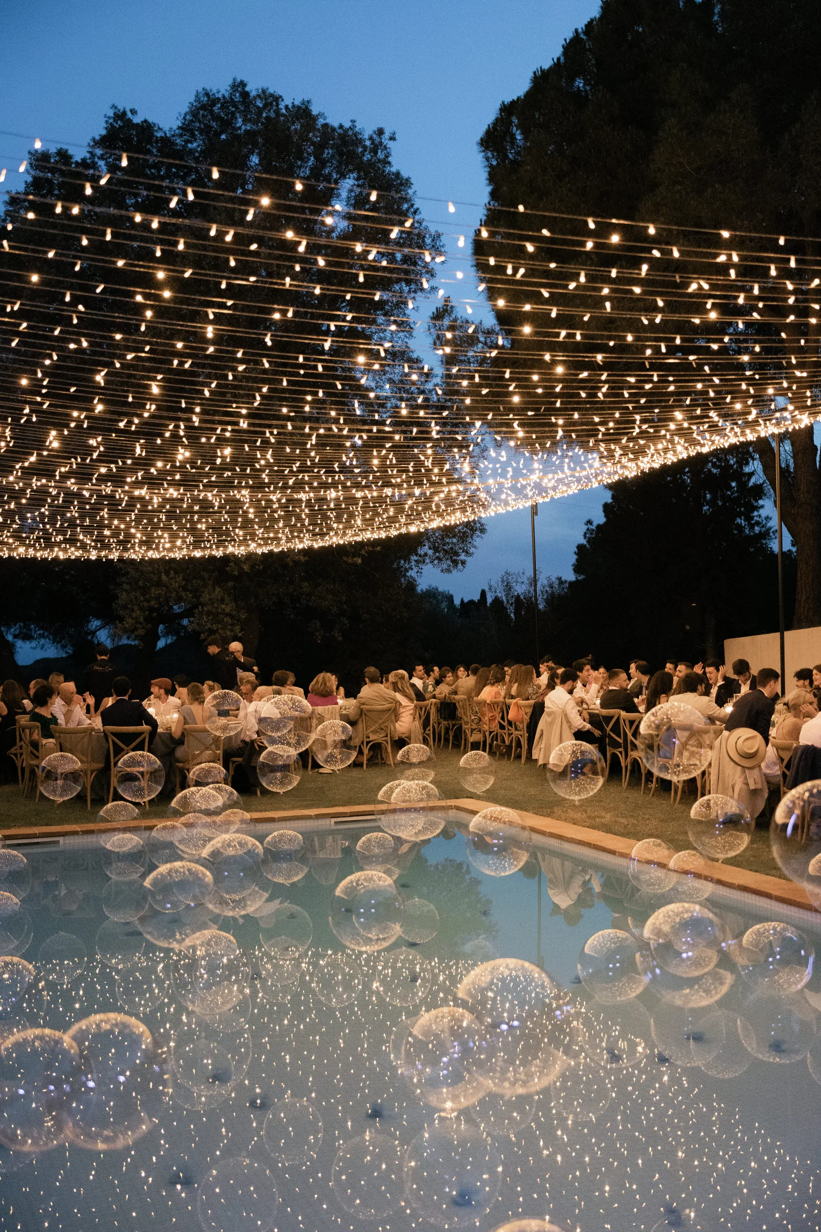 Black and gold photo booth backdrop with pampas grass and balloon garlands at the Lily is Gold event